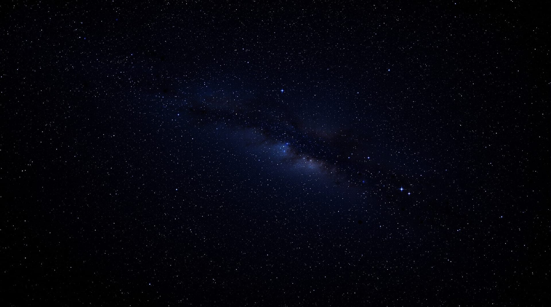Dense star field with a faint band of the Milky Way